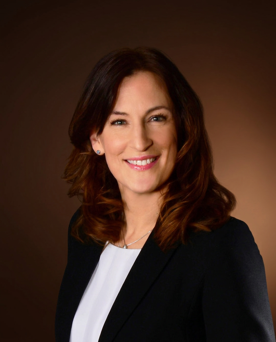 Portrait of plastic surgeon Tiia Pihlamaa wearing a white clinical coat
